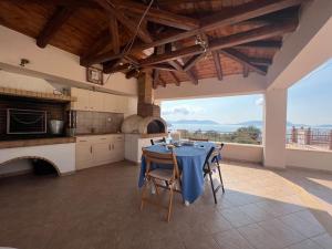 a kitchen with a table with a blue table cloth at Ermioni Sea View Villa in Ermioni