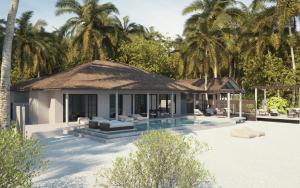 a villa with a swimming pool and palm trees at Villa Haven Maldives Resort in Maamigili