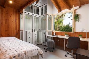 um quarto com uma cama, uma secretária e uma janela em 4 bedrooms house with private pool and wifi at Alcudia na Alcúdia