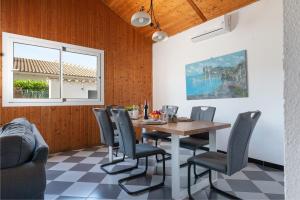 a dining room with a table and chairs at 4 bedrooms house with private pool and wifi at Alcudia in Alcudia