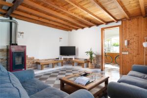 a living room with a couch and a fireplace at 4 bedrooms house with private pool and wifi at Alcudia in Alcudia