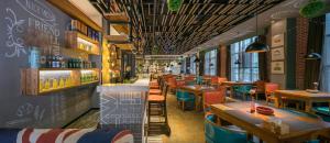 Mehood Theater Hotel, Changzhou Dinosaur Park في تشانغتشو: مطعم مع طاولات وكراسي وبار