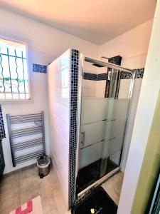 La salle de bains est pourvue d'une douche avec une porte en verre. dans l'établissement Agréable Villa 8pers avec vue mer LOGEMENT ENTIER, à Rognac