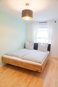 a bedroom with a wooden bed with a window at Ferienwohnung Montabaur in Montabaur