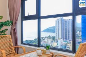 a dining room with a view of the ocean from a window at FLC Sea Tower - Seaview Apartment in Quy Nhon
