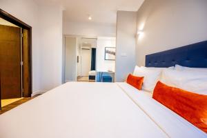 A bed or beds in a room at Urban by CityBlue, Dar es Salaam