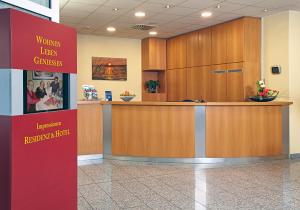 a waiting area in a hospital lobby with a reception counter at Hotel & Residenz Am Kurpark in Schlangenbad