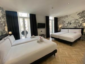 Postel nebo postele na pokoji v ubytování Oriente Atiram Hotel