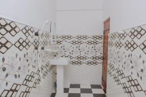 a bathroom with a shower with a toilet and a sink at Lucky Bay in Arugam Bay