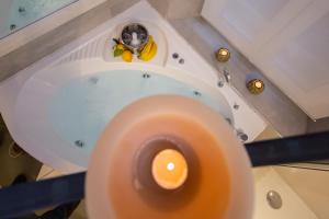 an orange candle on a table with bananas on it at Town House Spagna- luxury Rooms with Jacuzzi Bath in Rome