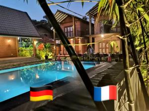 a villa with a swimming pool at night at MILLET'S FOOD COMPANY AND COOKING CENTER in Negombo