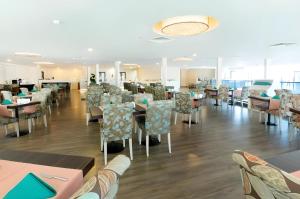 a dining room with tables and chairs and a cafeteria at Orbi Batumi City Hotel in Batumi