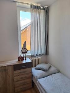 A bed or beds in a room at Vila Lomnička