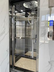 a glass elevator in a building with a ceiling at Windy Homestay Phan Thiết in Phan Thiet