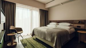 Postel nebo postele na pokoji v ubytování PURO Hotel Poznań Stare Miasto