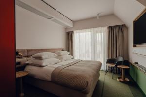 Postel nebo postele na pokoji v ubytování PURO Hotel Poznań Stare Miasto