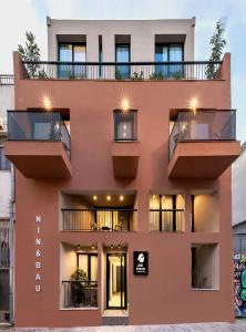 an apartment building with balconies and lights at Bonnie Athens by Nin&Bau in Athens