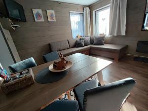 a living room with a table and a couch at Apartmany Adavy in Liptovský Mikuláš