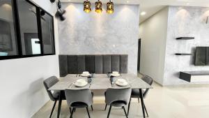 a dining room with a table and chairs at The Cove Hillside Residence Ipoh in Ipoh +77 photos