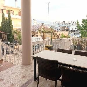 a table and chairs on a balcony with a view at Mamouth Studios in Chania Town