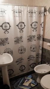 a shower curtain in a bathroom with a toilet and a sink at Departamentos Parque Benegas in Godoy Cruz