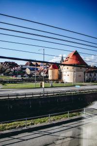 a city with buildings and a street with power lines at Contact Apartman in Bardejov