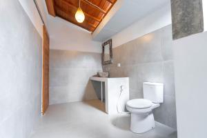 a bathroom with a toilet and a sink at Arshaka Villa in Amed +20 photos