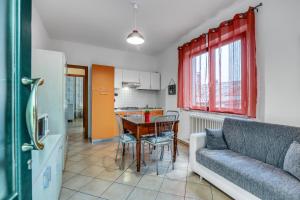 a living room with a couch and a table at Il Conero Bilocale con posto auto privato in Osimo