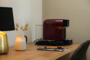 a coffee maker sitting on a wooden table at Mazzini's Rooms in Modena