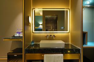a bathroom with a sink and a mirror at Mehood Hotel Shanghai Lujiazui in Shanghai
