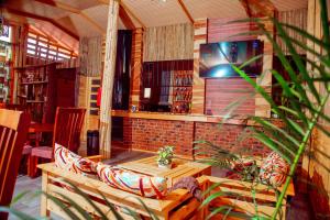 a room with a couch and a table in a library at WILLOW INN in Dodoma