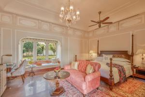 a bedroom with a bed and a pink couch at Mementos by ITC Hotels Jaipur in Jaipur +17 photos