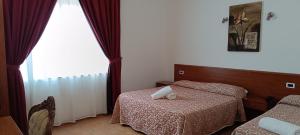 Postel nebo postele na pokoji v ubytování Desusino Residence & Hotel