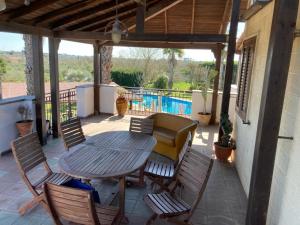 a patio with a table and chairs and a couch at Agriturismo Villa Pina in Lizzanello