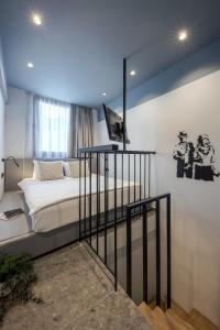 a bedroom with a bed and a tv on the wall at Bonnie Athens by Nin&Bau in Athens