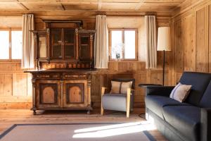 a living room with a couch and a cabinet at Wassermann in Sesto