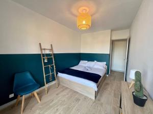 1 dormitorio con cama, escalera y silla en Le P'tit Anatole - Joli T2 avec parking en Poitiers