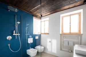 a bathroom with a shower and a toilet and a sink at Wassermann in Sesto