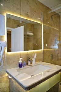 a bathroom with a sink and a mirror at ESSENCE GRANDEUR in Guwahati