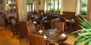 a dining room with a table and chairs at New Overlander Inn in Tenby
