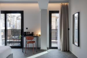 a bedroom with a table and a chair in a room at Bonnie Athens by Nin&Bau in Athens
