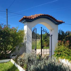 a gate to a villa with a garden at Arrifana Pines in Aljezur