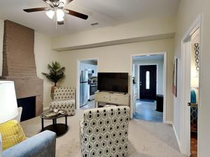 a living room with a couch and a tv at Barnard Row 1406 in Savannah