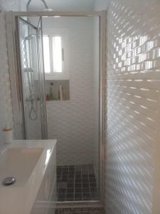 a bathroom with a shower and a white sink at Mi casica de Bogarra in Bogarra