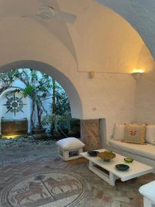 a living room with a couch and a table at Dar Essarouel Hammamet in Hammamet