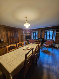 a dining room with a table and chairs at L'Atelier du Temps - Casa Ronc in Etroubles