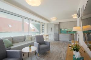 a living room with a couch and a table at Marina Apartman Balatonszemes by BLTN in Balatonszemes