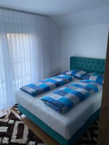 a bed with a blue and white in a room at Villa Green in Sarajevo