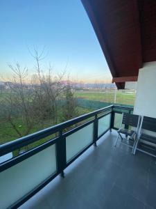a balcony with a chair and a view of a field at Villa Green in Sarajevo