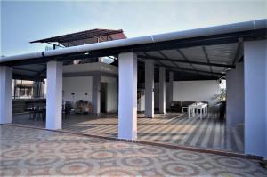 a house with a large deck with a table and chairs at ESSENCE GRANDEUR in Guwahati